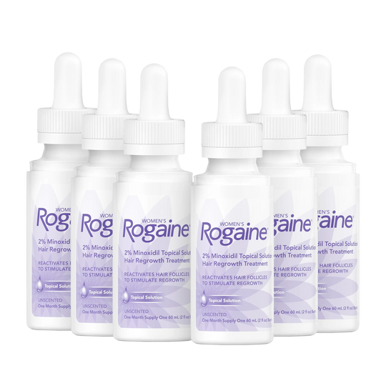 Six purple bottles of Women's ROGAINE® Topical Solution on a white background.