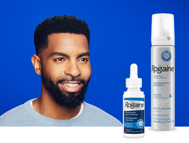 Man with beard and curly hair wearing a light blue sweater on a dark blue background. Featuring bottles of Men's Rogaine Foam and Topical Solution.