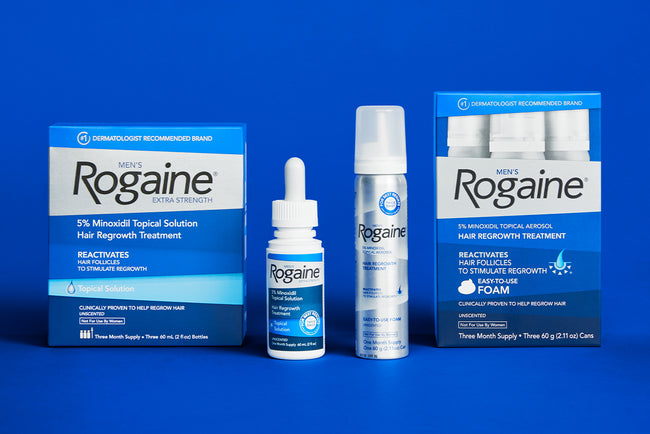 Bottles and boxes of Men's ROGAINE® Topical Solution and Foam on a blue background.
