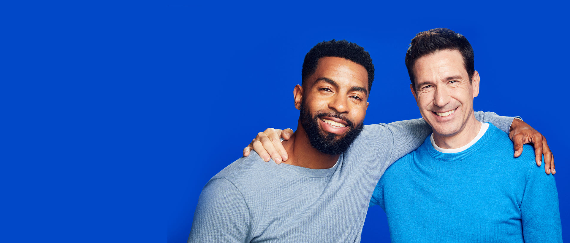 Two men wearing light blue sweaters on a blue background. Text indicating that you can unlock 15% off when you take a quick rogaine quiz to discover the right formula for you.