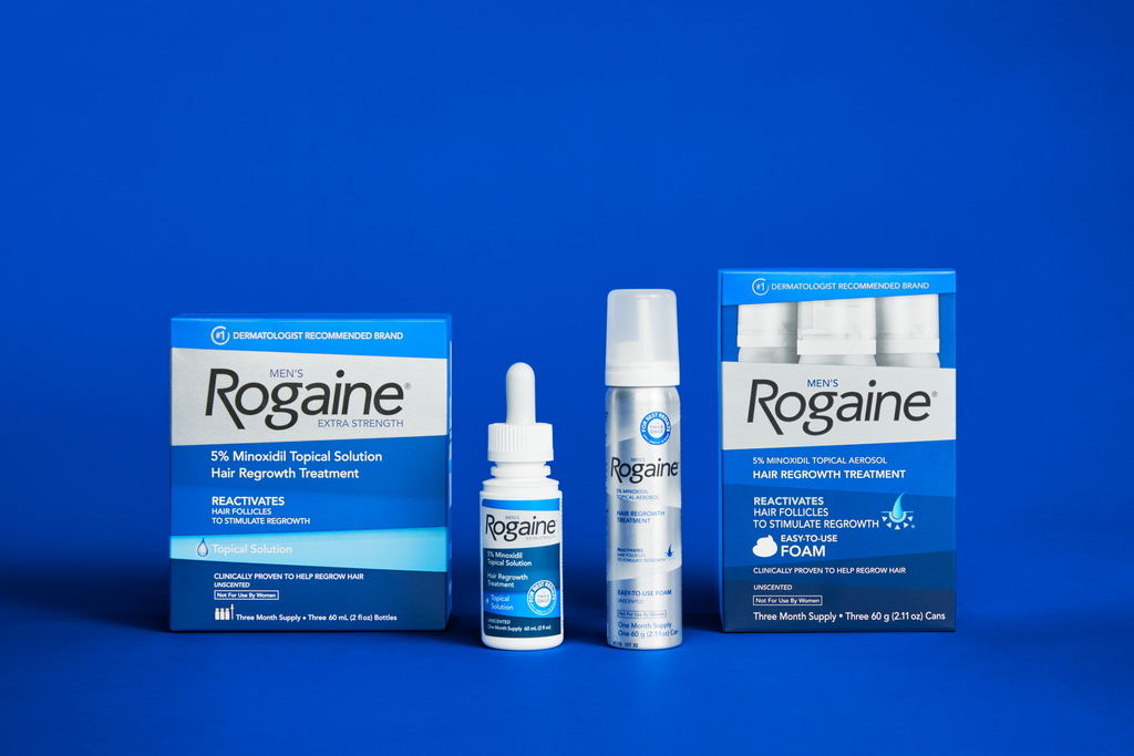 Bottle of Men's Topical and Foam Solution on a dark blue background. 